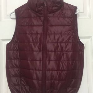 a burgundy zip up vest